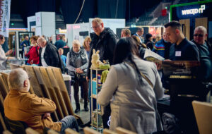 Exhibition fair full of people, warm atmosphere