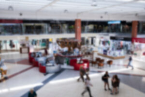 blurred indoor exhibition, people walking around